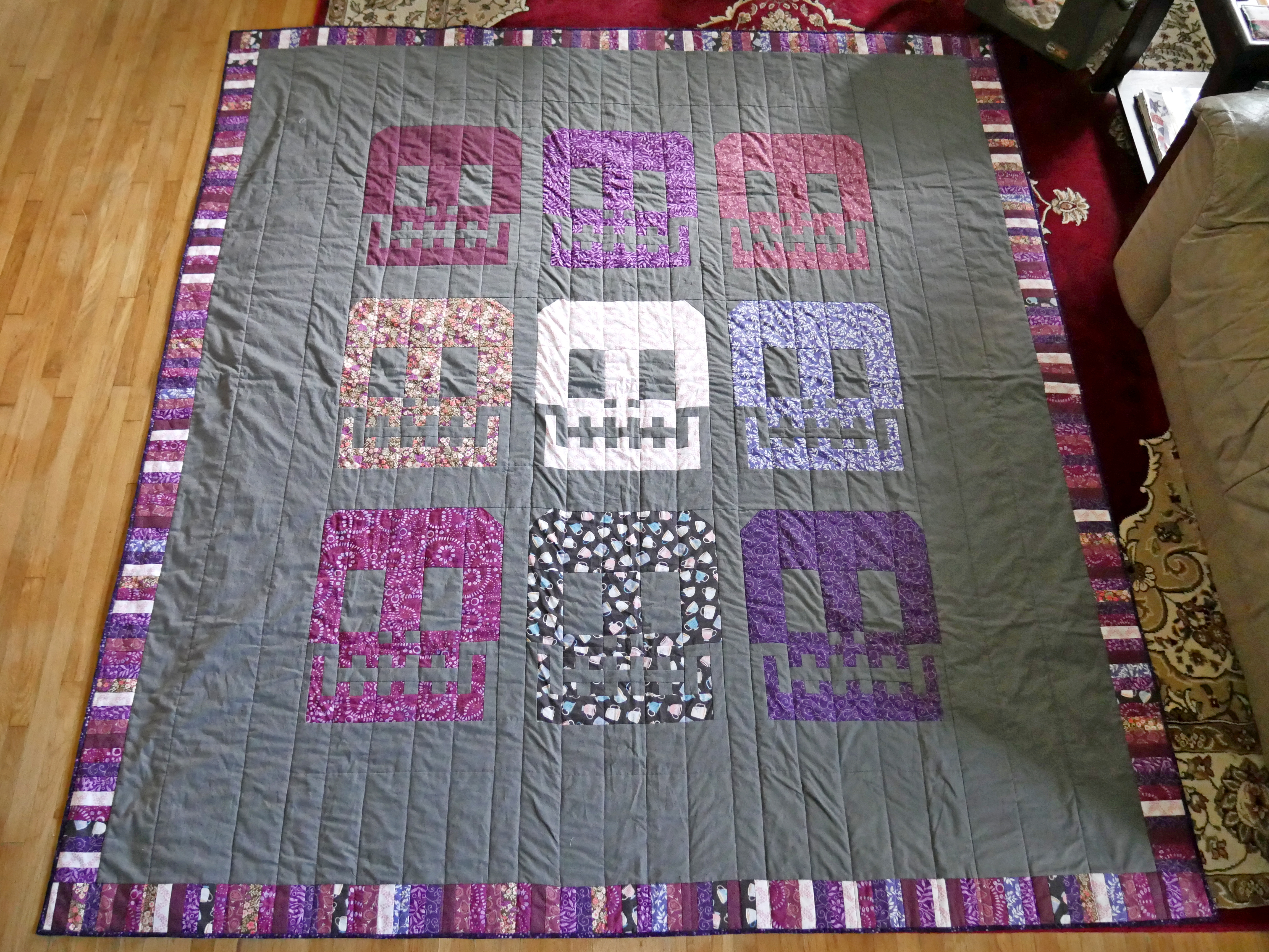 A quilt with a skull design.